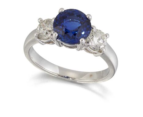 A SAPPHIRE AND DIAMOND THREE STONE RING, a round-cut sapphire between round brilliant-cut diamonds. Estimated total diamond w