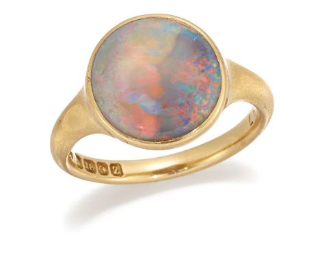 AN 18 CARAT GOLD BOULDER OPAL RING, a round opal in a bezel setting to a tapering shank. Hallmarked Birmingham 1899, ring siz