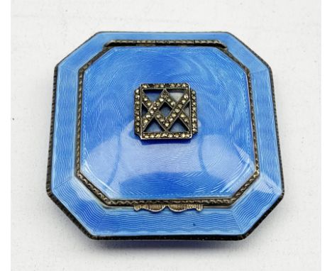 Silver and blue enamel compact, cushion shape and of octagonal design, the hinged cover with marcasite panel, gilded and mirr