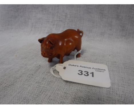 A CARVED WOODEN NETSUKE STYLE FIGURE OF A PIG
