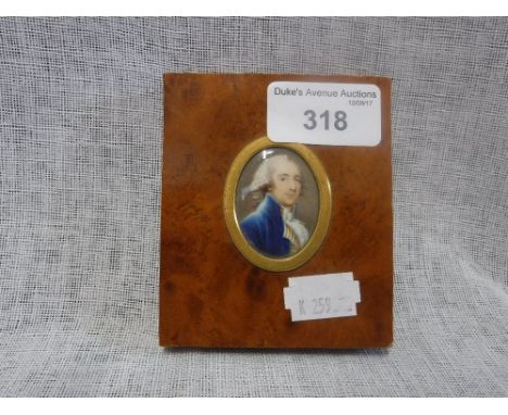 AN OVAL PORTRAIT MINIATURE OF A GENTLEMAN wearing a blue coat