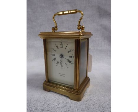 A BRASS-CASED CARRIAGE CLOCK with white enamel dial