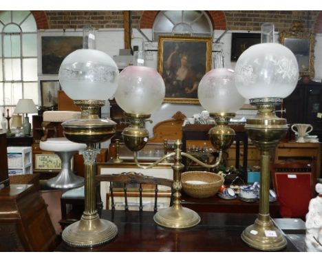 A LARGE BRASS CORINTHIAN COLUMN OIL LAMP and two others similar 