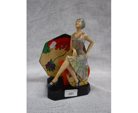 A KEVIN FRANCIS FIGURE 'Tea with Clarice Cliff', a woman seated on a milk jug beside a plate