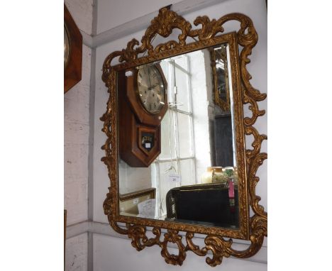 A LARGE GILTWOOD TABLE LAMP in the form of an altar candlestick and a wall mirror in a gilt frame (2)