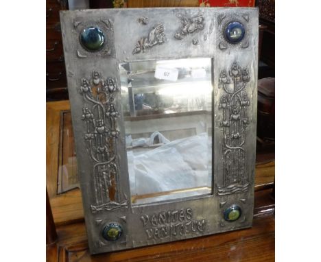 AN ARTS & CRAFTS WALL MIRROR in an embossed pewter frame, inscribed 'Vanitas Vanitatum' with four glazed ceramic roundels 17"