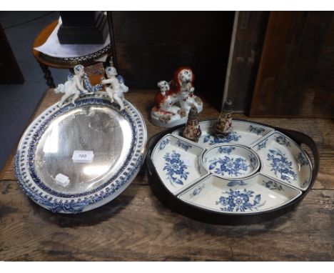 A LATE 19TH CENTURY DRESDEN CERAMIC FRAMED OVAL WALL MIRROR, the top decorated with cherubs, a blue and white Booth's hors d'