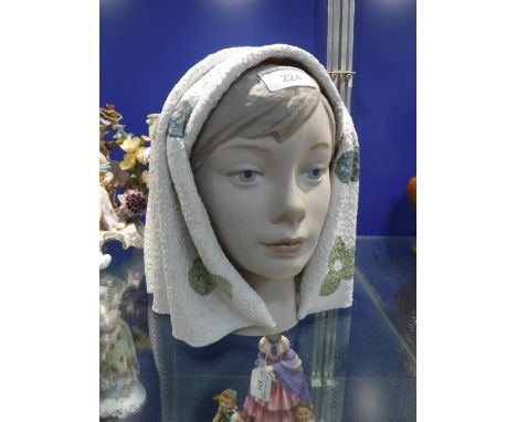 A LLADRO CERAMIC BUST of a young woman wearing a headscarf