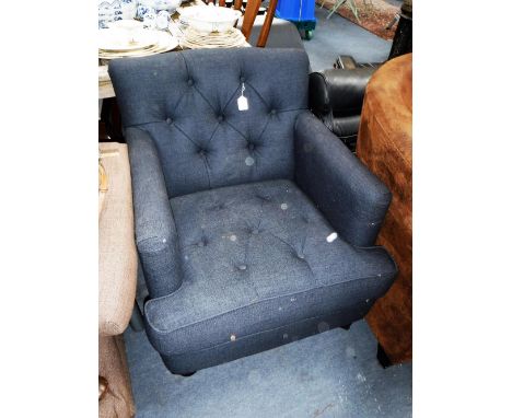 A MODERN BUTTON-BACK ARMCHAIR upholstered in charcoal material on turned feet