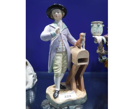 A CONTINENTAL CERAMIC FIGURE OF A MAN standing by a box with small dog