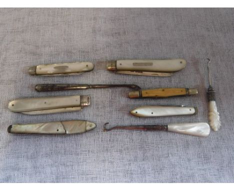 A SILVER PENKNIFE with mother-of-pearl handle and a collection of similar items