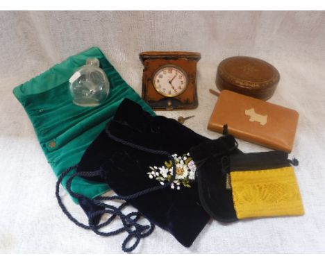 A LEATHER CASED TRAVELLING CLOCK, a small collection of purses and other items