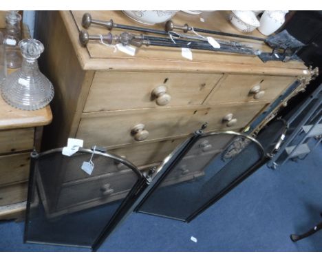 A SET OF THREE EDWARDIAN BRASS AND IRON FIRE TOOLS and a four-fold guard