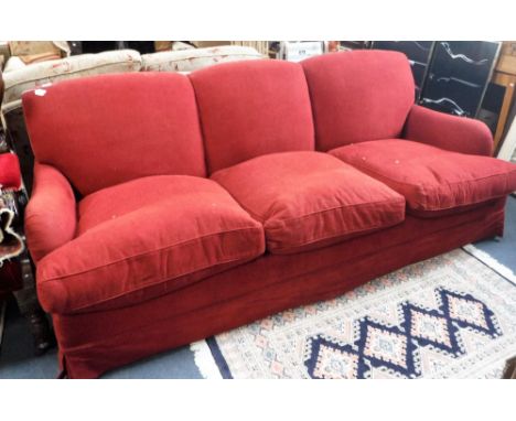 A MODERN THREE SEATER HOWARD STYLE 'KINGSCOMBE' THREE SEATER SOFA upholstered in red material, on tapering beech legs, 92" wi