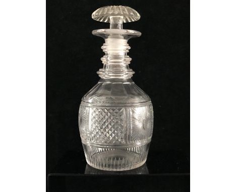 Irish Glass - A cut glass three ring neck decanter with mushroom stopper, the body of mallet form, cut with a starburst flank