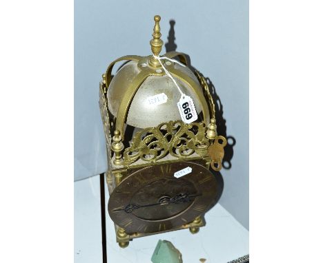 A LARGE BRASS LANTERN CLOCK, with Roman numeral dial, on ball feet, height approximately 38cm (key and pendulum) 