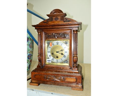 A JUNGHANS REPEATING BRACKET CLOCK, having a brass face with a silvered chapter ring and Roman numerals, the case being of oa