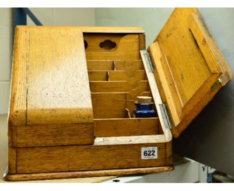 A LIGHT OAK SLOPING FRONT STATIONARY BOX, the twin doors opening to a fitted interior, approximate width when closed 30cm (no
