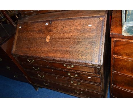A GEORGIAN OAK AND SATINWOOD INLAID FALL FRONT BUREAU, with a fitted interior above two short and three long graduated drawer