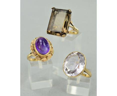 THREE LARGE SINGLE STONE GEM SET DRESS RINGS, to include one large pale mixed cut amethyst rub over set, head measuring appro