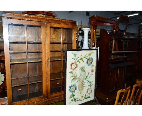 AN EDWARDIAN MAHOGANY HANGING WALL SHELF, with two drawers and double cupboard doors (sd) and an oak two door bookcase (2)