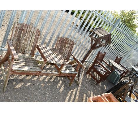 A WOODEN TWO SEATER GARDEN BENCH, with central table top, a rustic bird house, two wooden garden seats and a metal framed gar