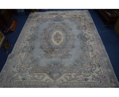 A CHINESE WOOLLEN CARPET SQUARE, light blue and cream ground with floral design, approximate size 320cm x 240cm