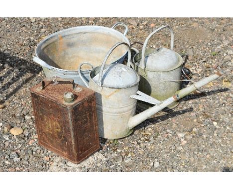 A VINTAGE ESSO PETROL CAN, two galvanised watering cans and a galvanised bath (4)