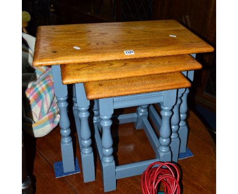 A LIGHT OAK AND PAINTED NEST OF THREE TABLES
