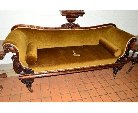 AN EARLY VICTORIAN MAHOGANY AND WALNUT SOFA, the scrolled arms above foliate carved detail on tulip and floral carved legs wi