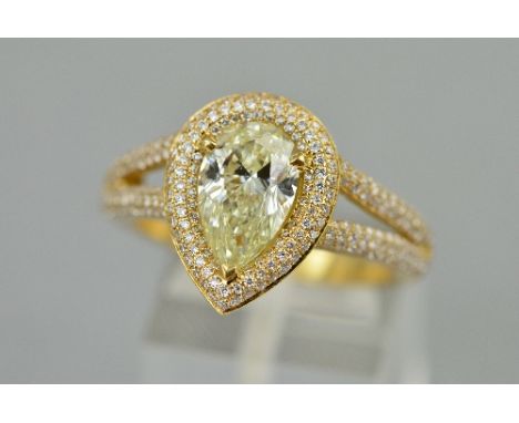 A LARGE MODERN PEAR-SHAPED DIAMOND HALO RING, centring on a modern pear shape cut diamond, measuring approximately 10.85mm x 