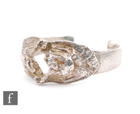 Knud V. Andersen - Anton Michelsen - A Danish silver brutalist bangle with textured organic decoration with central aperture.