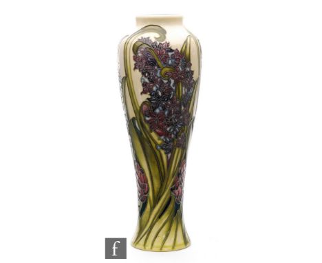 Kerry Goodwin - Moorcroft Pottery - A vase of slender form decorated in the Florian Hyacinth pattern, impressed and painted m