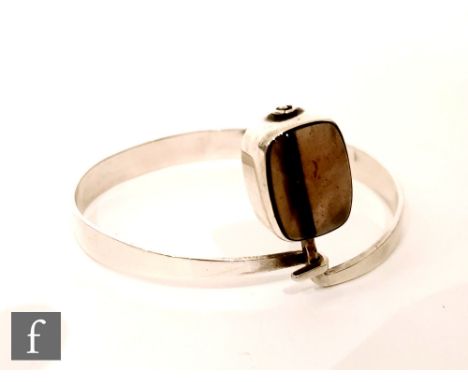 Kalevala Koru - A Finnish silver modernist bangle set with smoke grey glass in a rectangular surround, hallmarks for 1973. 