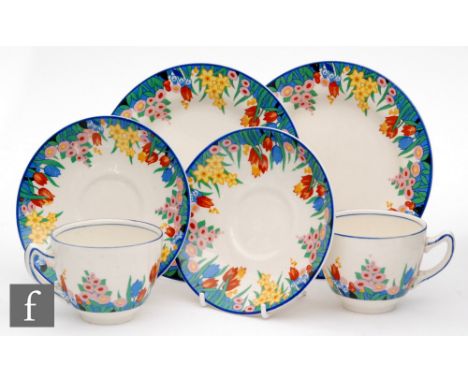 Clarice Cliff - Chloris - A pair of tea cups and saucers transfer printed with a band of flowers and foliage with matched sid