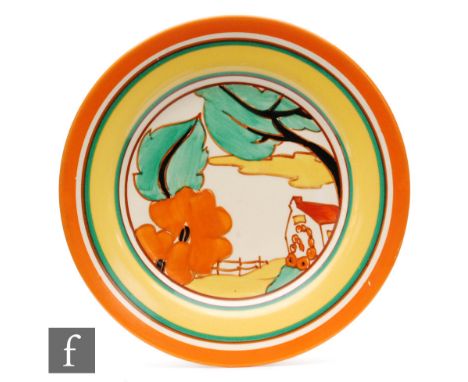 Clarice Cliff - Red Roofs - A circular plate circa 1931, hand painted with a stylised tree and cottage landscape with graduat