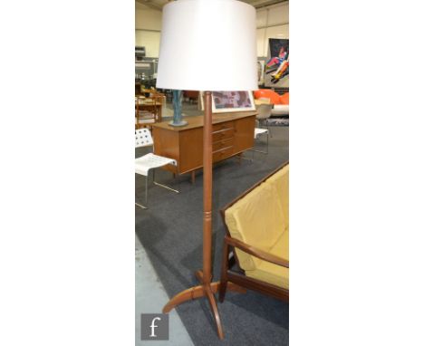 Unknown - A teak floor lamp raised to a cruciform base, height 134cm (excluding the bulb fittings). 