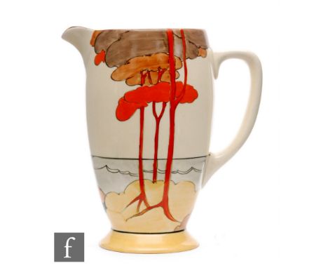 Clarice Cliff - Coral Firs - A Coronet shape jug circa 1932, hand painted with a stylised tree lined coastal scene with yello