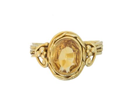 A citrine dress ring, A citrine dress ring, the oval shape citrine within a beaded and wirework surround, to the scrolling ba