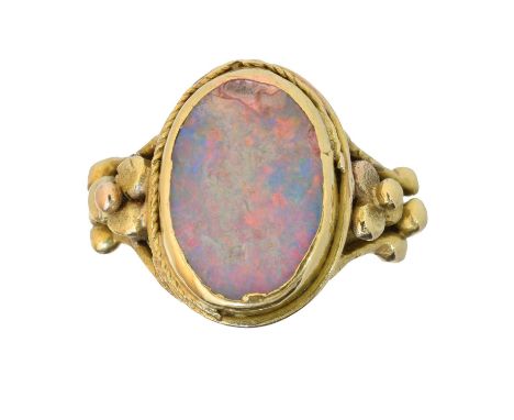 An early 20th century 18ct gold opal dress ring,  An early 20th century 18ct gold opal dress ring, the oval opal panel with f