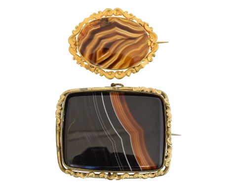 Two agate brooches, Two agate brooches, each with a scrolling surround, lengths 5.9 &amp; 7cm, gross weight 62.5g.Overall con