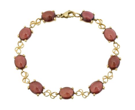 A 9ct gold garnet bracelet, A 9ct gold garnet bracelet, the oval garnet cabochon line with fancy link spacers, length 19.5cm,