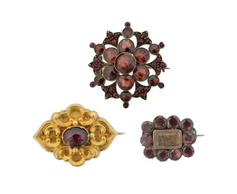 Three 19th century garnet brooches,  Three 19th century garnet brooches, of varying design, one with glazed hair panel to rev
