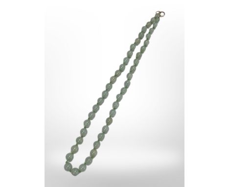 A graduated jade bead necklace with yellow gold clasp, length 43 cm.