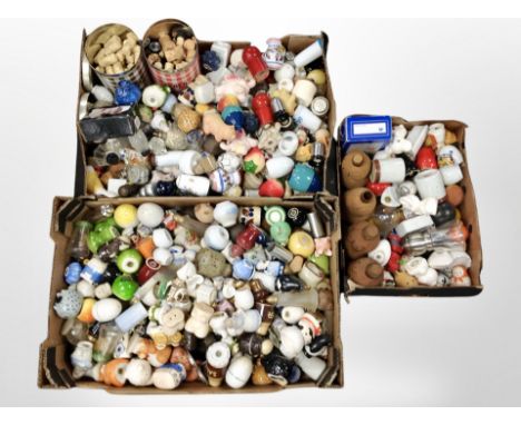 Three boxes containing a large quantity of ceramic salt and pepper sifters, bottles, etc.