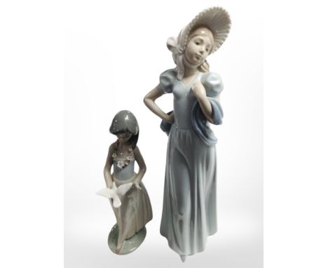 A Lladro figure of a girl holding a dove, no. 6157, together with a further Nao figure of a lady wearing a bonnet