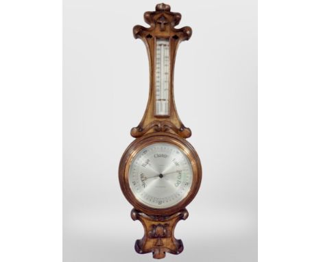 An oak barometer with silvered dial, signed J. Durkin, Middlesbrough, length 83cm.
