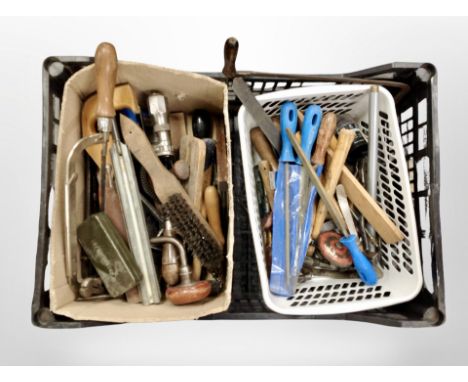 A crate containing assorted vintage hand tools.