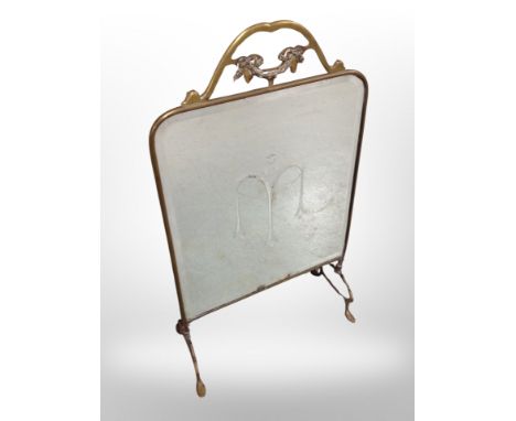 A mirrored brass fire screen, height 78 cm 