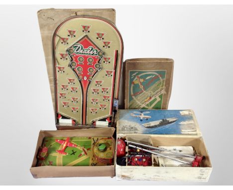 A box of vintage tin plate toys including bagatelle board, remote control helicopter, etc.